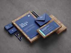 a wooden table topped with blue business cards