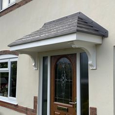 a house with a brown door and windows