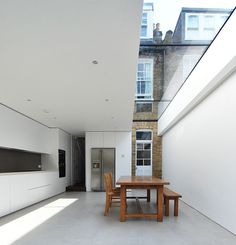 an empty room with a table and chairs in it