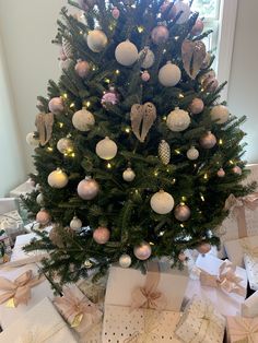 a decorated christmas tree with presents under it