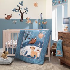 a baby crib bedding set with bears and trees on the wall behind it