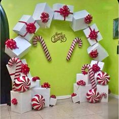 a christmas wreath made out of boxes and candy canes