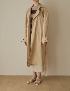 A cool variation of the classic trench, the Lotte Trench features a relaxed, slouchy silhouette with cinchable waist and wrists, rounded shoulders, and deep patch pockets. Also available in dark beige. - Overcut- Pointed collar- Top button closure- Half storm front and back- Removable storm neck piece- Belted waist and cuffs- Angled patch pockets- Back vent- Fully lined- Measurements Length 45.5", Bust 52", Sleeve 31.5"- Outer: 100% Cotton, Lining: 100% Polyester- Dry clean- Imported Trench Lighter, Storm Front, Dark Beige, Neck Piece, Collar Top, Light Beige, Duster Coat