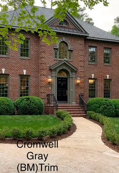 a large brick house with landscaping around it