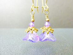 Lavender Earrings Purple Earrings Flower Earrings, Handmade Jewelry, Vintage Style, Czech Bell Flower EarringsDeep lavender purple czech glass bell flower earrings are encircled by brass filigree bead caps, topped with lavender purple crystal bicones and hung on brass kidney hooks. These lavender flower earrings remind me of looking up from under the ocean, if the ocean were purple :-). I do have other lovely czech glass bell flower earrings in different rainbow shimmer colors, as shown in the l