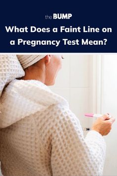 a woman brushing her teeth with the words what does a faint line on a pregnant test mean?