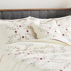 a bed with white and red flowers on it