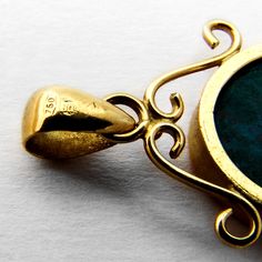 "Vintage 18 K (.750) yellow gold oval form pendant, decorated with inlaid Azurmalachite stone. This splendid pendant is 1 1/4\" long (including the bail), 5/8\" wide and weighs 4.2 grams. EA636" Traditional Gold Jewelry With Oval Cabochon, Gold Oval Pendant For Vintage Collection, Formal Oval Malachite Jewelry, Oval Malachite Jewelry In Yellow Gold, Antique Blue Oval Pendant Jewelry, Blue Oval Pendant Jewelry, Engraved, Yellow Gemstone Oval Pendant Necklace, Yellow Gold Malachite Pendant Jewelry, Brass Oval Pendant With Cabochon