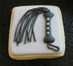 a cookie decorated with icing and some type of hair clip on top of it