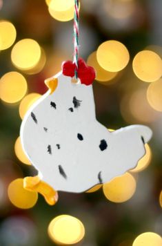 a white ornament hanging from a christmas tree