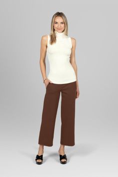 Full outfit featuring the Traveler Ankle Pant in dark khaki paired with a white top, showcasing a chic and versatile look perfect for casual outings Travel Pant, Effortlessly Chic Outfits, Travel Pants, Sleeveless Turtleneck, Dark Khaki, Tres Chic, Ankle Length Pants, Ankle Pants, Tight Leggings