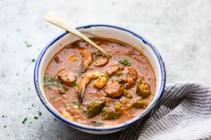 a bowl of soup with shrimp and jalapenos