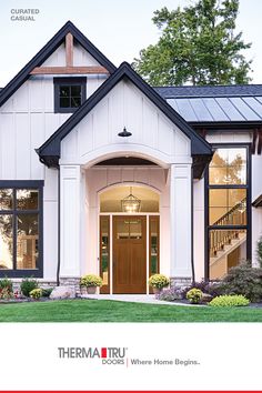 an advertisement for therma tru doors and windows, featuring a white house with black trim