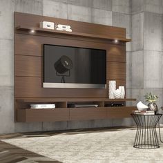 a living room filled with furniture and a flat screen tv on top of a wooden entertainment center