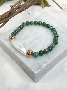 "Celebrate your May birthday with this Emerald birthstone bracelet, or just because you love this stunning green stone. Made with high quality emerald beads that show a rich green color. Center bead is a Troca Shell.  Emeralds supports success in love; promotes with faithfulness; creates unity; increases positivity; imparts wisdom.  ~ Crystals for Healing Bracelets are approximately 7 1/4 to 7 1/2\". If a different size is desired please feel free to message me and I will make what ever size is Crystals For Healing, Bracelet Emerald, Elastic Bracelets, Emerald Birthstone, May Birthday, Emerald Bead, Birthstone Bracelet, What Ever, May Birthstone