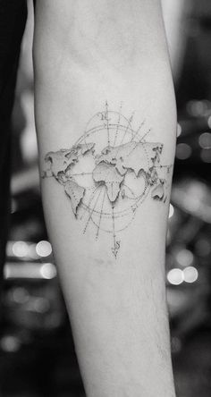 a man with a tattoo on his leg that has a world map drawn on it