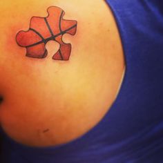 a woman with a tattoo on her back has a piece of puzzle in the shape of a heart