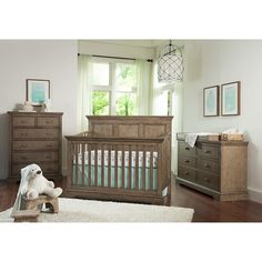 a baby's room with a crib, dresser and bed