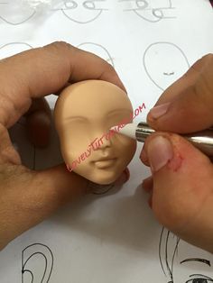 someone is drawing a dummy with a marker