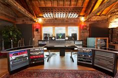 a recording studio with multiple monitors and sound equipment