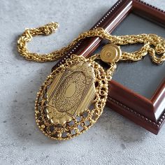 Vintage oval locket necklace with photo.  Metal - gold-tone jewelry metal Stone -  Size - pendant 2 1/2''-2'', chain 24'' Mark - Florenza Circa the 1960s -70s Condition -  vintage good condition.  PLEASE NOTE: Vintage jewelry can show signs of wear and discoloration or chipped metal consistent with age. Please look at the pictures carefully. Most were purchased at estate sales, auctions, etc. so they could need cleaning. If you need additional pictures or have questions, please contact me prior Elegant Gold Locket Necklace, Gold Locket Necklace With Vintage Charm, Gold Pendant Locket Necklace With Vintage Charm, Vintage Gold Medallion Necklace With Chain, Antique Gold Medallion Necklace For Gift, Gold Engraved Oval Link Chain Necklace, Victorian Gold Brass Locket Necklace, Gold Metal Locket Jewelry, Gold Metal Pendant Locket Necklace