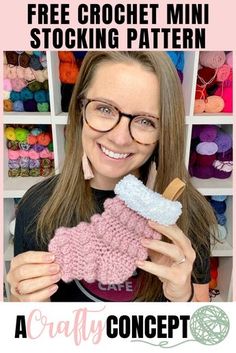 a woman holding up a pink knitted boot with the words free crochet mini stocking pattern