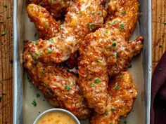 chicken wings with dipping sauce on the side