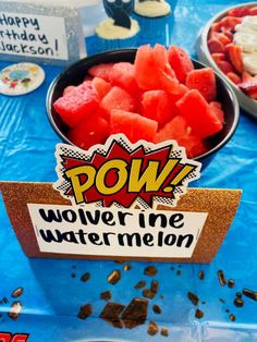 a bowl of watermelon cut into pieces on top of a blue table cloth