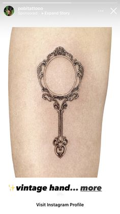 the back of a woman's thigh with an ornate key tattoo design on it