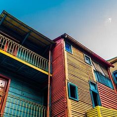 multicolored wooden buildings with balconies and windows