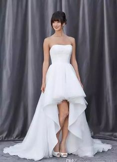 a woman in a white dress posing for the camera