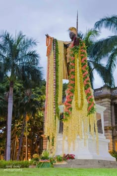 the statue is decorated with flowers and garlands