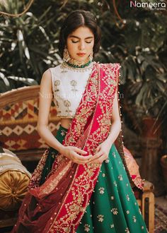 White and Green Lehenga Choli for Wedding Wear is stunningly embroidered in dabka, tilla, and sequins work on white raw silk choli paired with Raw Silk Green Lehenga and Net Pink Dupatta. ﻿A blossoming pink hue dupatta is paired up with a handcrafted mastery of pearls, zardosi, and sequins laid over an emerald green lehenga and a white choli in pure raw silk. Choli: Beautiful dress is gonna make your big day more beautiful in its design and styling having embroidered choli in without sleeves inc Lehenga Choli For Wedding, Choli For Wedding, Wedding Makeover, Green Lehenga Choli, Silk Fabric Dress, Brocade Lehenga, Mehendi Outfit, Desi Fits, Haldi Outfits