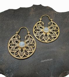 Add a touch of Bohemian elegance to your look with these handmade silver brass boho earrings. The stunning Moonstone or Coral gemstones are the focal point of the piece, complemented by an intricate filigree mandala. Perfect for any occasion, whether you are looking to add a touch of ethnic flair or simply elevate your every day style. Crafted from high quality jewellery brass, nickel free. The piece measures 5 cm in high and 4 cm in diameter. Suitable for women of all ages, these earrings make Bohemian Dangle Brass Jewelry, Bohemian Brass Dangle Jewelry, Bohemian Bronze Earrings With Intricate Design, Intricate Design Moonstone Jewelry, Bohemian Bronze Jewelry For Wedding, Spiritual Moonstone Jewelry For Festivals, Ornate Brass Jewelry For Festive Occasions, Handmade Ornate Chandbali Jewelry, Ornate Brass Festive Jewelry