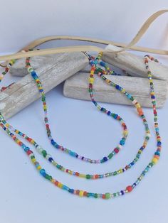 These lovely single strand beaded necklaces are great for adding a pop of colour. They are thin and dainty. Using a variety of 2-4mm as well as some bugle beads, they are randomly threaded so no 2 are alike.  The length (diameter) of the necklace is including the clasps and endings so please measure carefully to ensure you choose the correct length for yourself.  A 5cm extension chain can be added if needed. - This listing is for 1 necklace.  - Handmade in the UK - Made to Order Postage is done Mixed Beads Necklace, Bugle Beads, Necklace Beaded, Seed Bead Necklace, Colourful Necklace, Beaded Necklaces, Necklace Handmade, Bead Necklace, Seed Bead