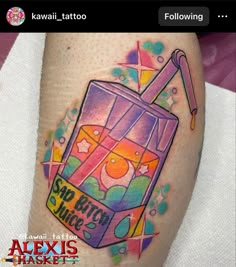 a colorful tattoo on the leg of a person with an orange juice box in it