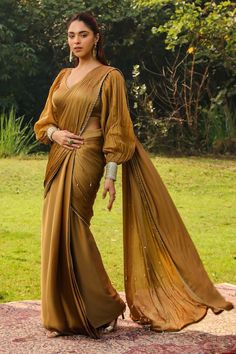 Honey gold pre-draped saree with a lace border, sequin and tassel embellishment. Paired with a blouse with princess balloon sleeves. - Aza Fashions Gold Pre-draped Saree With Cutdana In Traditional Drape, Bollywood Draped Traditional Evening Wear, Evening Eid Pre-draped Saree With Traditional Drape, Traditional Drape Pre-draped Saree For Eid Evening, Elegant Draped Silk Traditional Wear, Evening Pre-draped Traditional Saree For Eid, Eid Evening Pre-draped Traditional Saree, Gold Pre-draped Saree With Cutdana In Georgette, Gold Pre-draped Georgette Saree With Dupatta