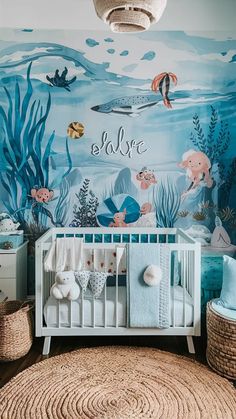 a baby's room with an ocean theme painted on the wall