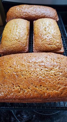 four loaves of bread cooling on a rack