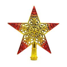 a red and gold metal star ornament on a white background