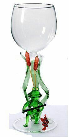 a glass vase with two red flowers in it and a frog figurine on the bottom