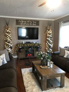 the living room is decorated for christmas with lights and garlands on the tree branches