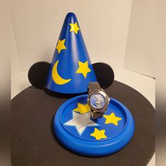 a blue plate with a watch on it and a party hat sitting on top of it