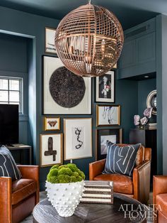 a living room filled with furniture and pictures on the wall