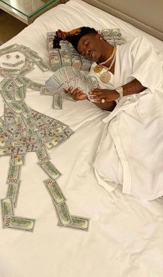 a woman laying on top of a bed covered in money