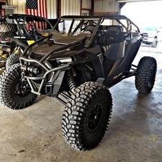 a can - am rzr is parked in a garage