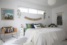 a bedroom with white walls and green accents