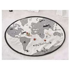 a round rug with the world map on it and pins pinned to each one's back