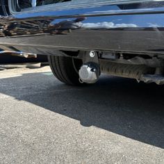 the rear end of a black car with its brake assembly missing from it's bumper