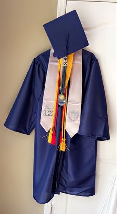 a blue graduation gown hanging on a door